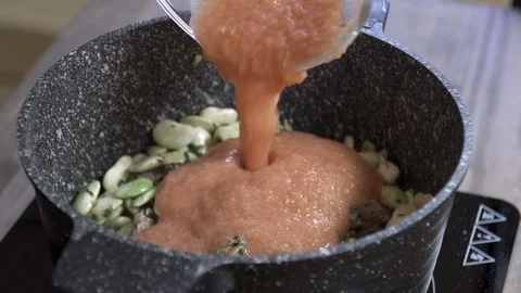 Adding mashed tomato to bean stew cooked with beef, Lebanese cuisine Stock Footage 122450378