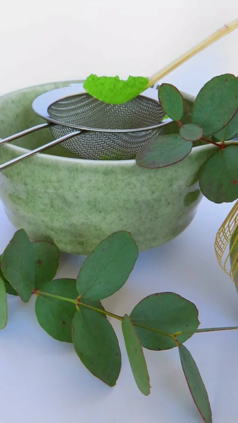 Adding Matcha Powder into Metal Sieve for Tea Preparation 4K Vertical Video 스톡 동영상 335640998