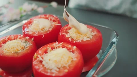 Adding Mayonnaise to Cheese Stuffed Tomatoes Stock Footage 253486023