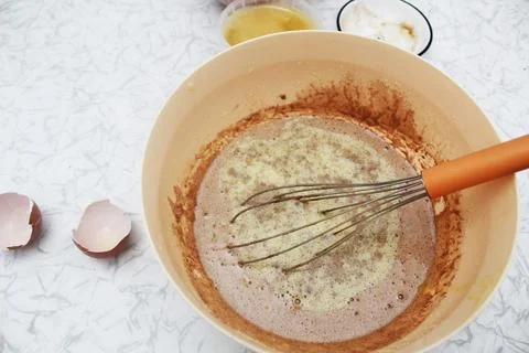 Adding melted butter to the dough. Top view Photos