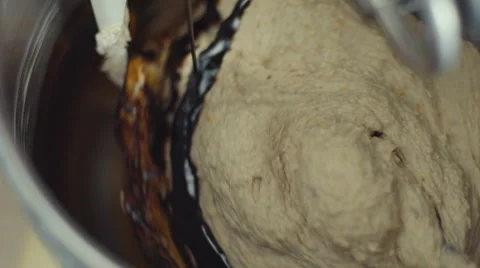 Adding melted chocolate into mixing dough Stock Footage 63264653