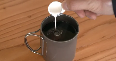 An adding milk and mixing coffee of work tools in office Stock Footage 122089558