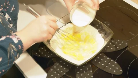 Adding milk and mixing the French pancake batter. Stock Footage 102400882