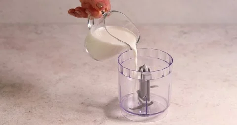 Adding milk in blender smoothy preparation Stock Footage 194104896
