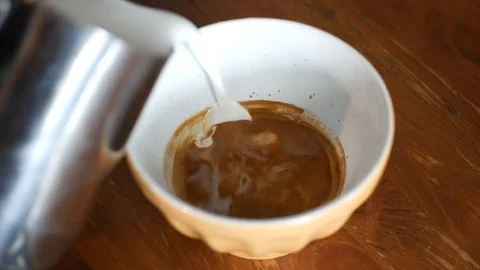 Adding milk to a coffee Video stock 113155841