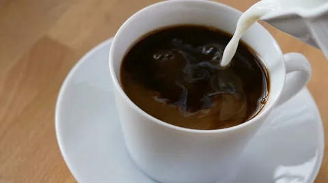 Adding milk to coffee, slow motion Stock Footage 48818608