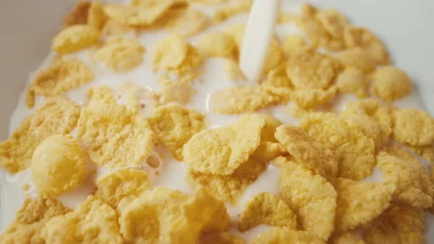 Adding milk to cornflakes cup 動画素材 197637493