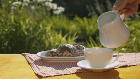 Adding milk into a cup of coffee Stock Footage 137623357