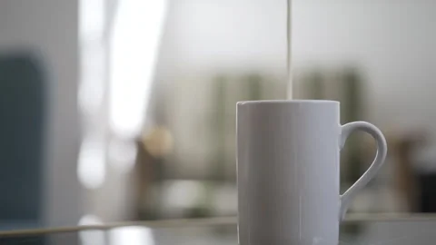 Adding milk to a cup of coffee Stock Footage 266801043