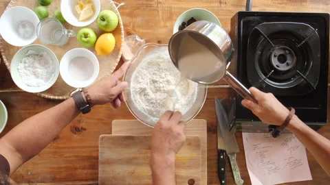 Adding Milk to Flour Top View, 4K Stock Footage 148187492