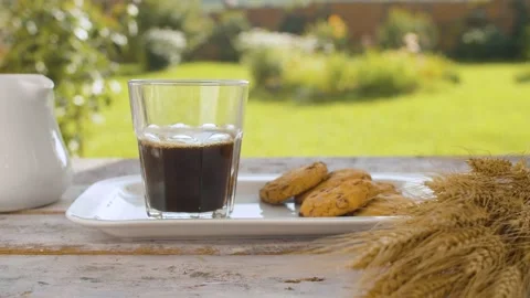 Adding milk into a glass of coffee Stock Footage 137808707