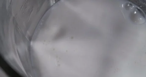 Adding milk in a glass container Stock Footage 92169461