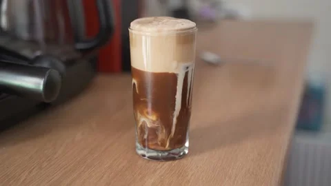 Adding milk in a glass, making instant coffee Stock Footage 139092941