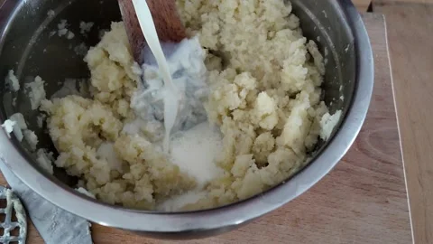 Adding milk to homemade mashed potatoes Stock-Footage 347018349