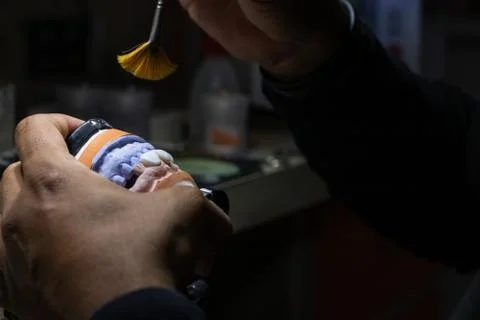 Adding more texture and finishing the prosthetic with a brush. Stock Photos
