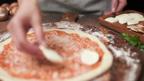 Adding mozzarella cheese on a pizza dough in 4K Stock Footage 137482199