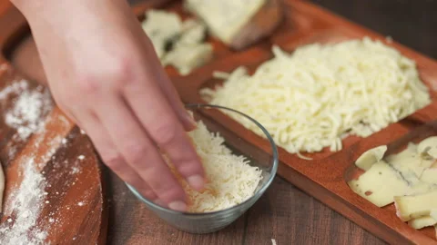 Adding mozzarella cheese on a pizza dough in 4K Stock Footage 137484142