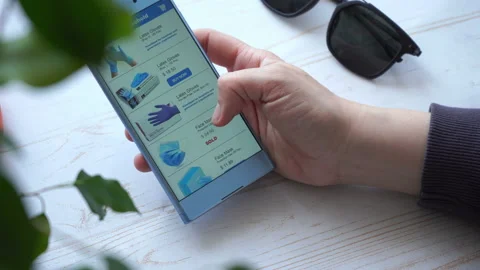 Adding the necessaries to the cart while online shopping with smartphone  Stock Footage 133342377