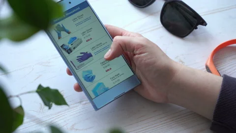 Adding the necessaries to the cart while online shopping with smartphone Stock Footage 133342506