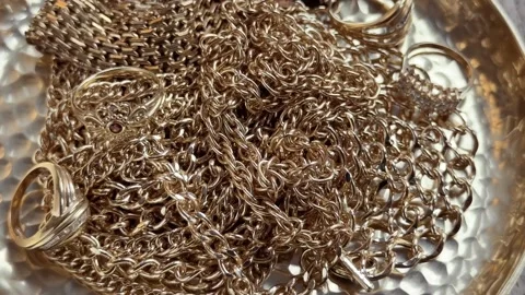 Adding necklace to jewelry pile Stock Footage 319003524