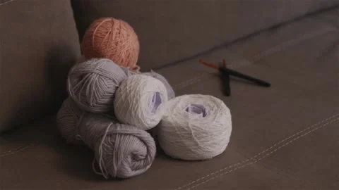 Adding a new ball of yarn to a large pile of wool threads Stock Footage 337452018