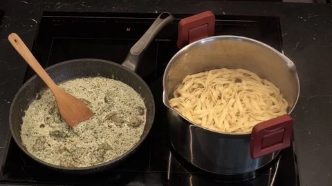 Adding noodles to sauce above view Stock Footage 113528224