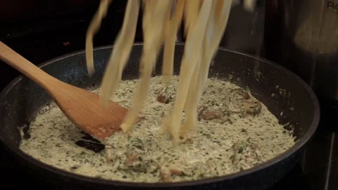 Adding noodles to sauce Stock Footage 113527229