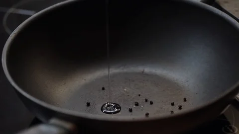 Adding oil and garlic closeup Stock Footage 97411040