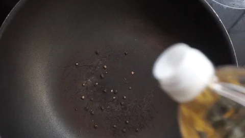 Adding oil and garlic Stock Footage 97410642