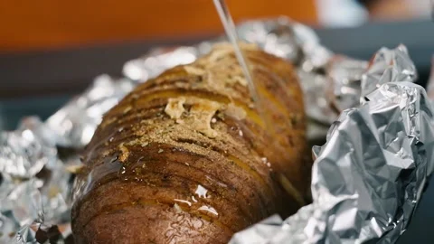 Adding oil on big sliced and spiced potato. Making homemade food. Preparing Video stock 132908993