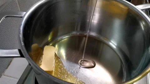 Adding Oil on Butter While Sauteeing Garlic Stock Footage 149408027