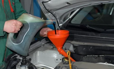Adding Oil to a Car 写真素材