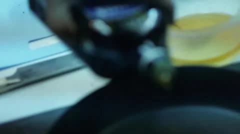Adding oil to the frying pan Stock Footage 12752330