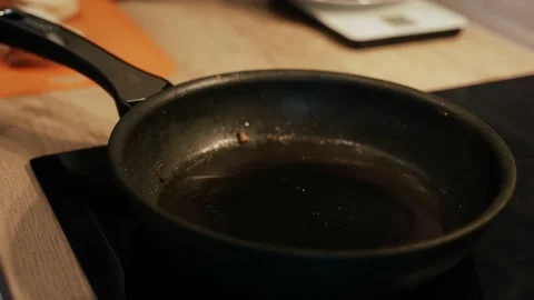 Adding the oil to the hot pan. Close-up Stock Footage 149597354