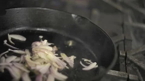 Adding oil into the pan containing onions Stock-Footage 307340076