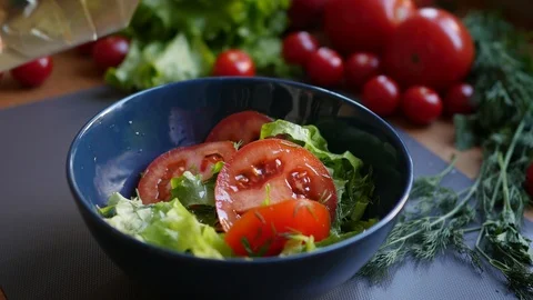 Adding oil in salad in bowl  Stock Footage 88771258