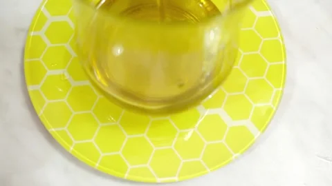 Adding olive oil to the bowl on a scale to get the right quantity for the recipe Stock Footage 320067468