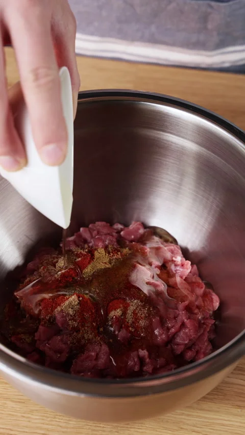 Adding Olive Oil To Raw Lamb In Metal Bowl Front View Видео 330340252