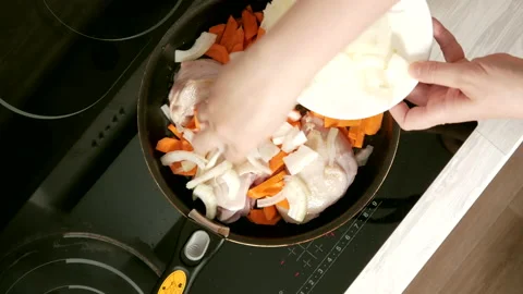 Adding onion to chicken Stock Footage 165501653