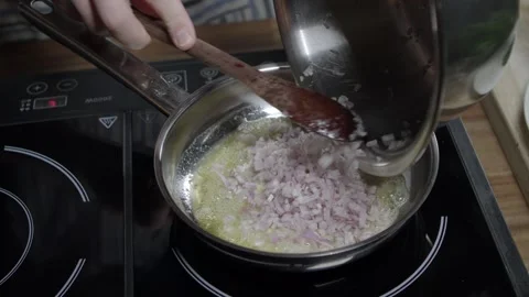 Adding onion to the meat sauce mixture, coffee in paris butter. Hot pan on Stock Footage 258878314