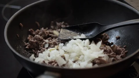 Adding onions and carrots Stock Footage 97411110