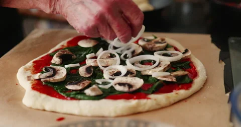 Adding onions to home made pizza Stock Footage 241607632