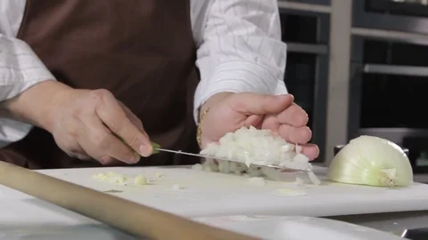 Adding onions to pot Stock Footage 77046383