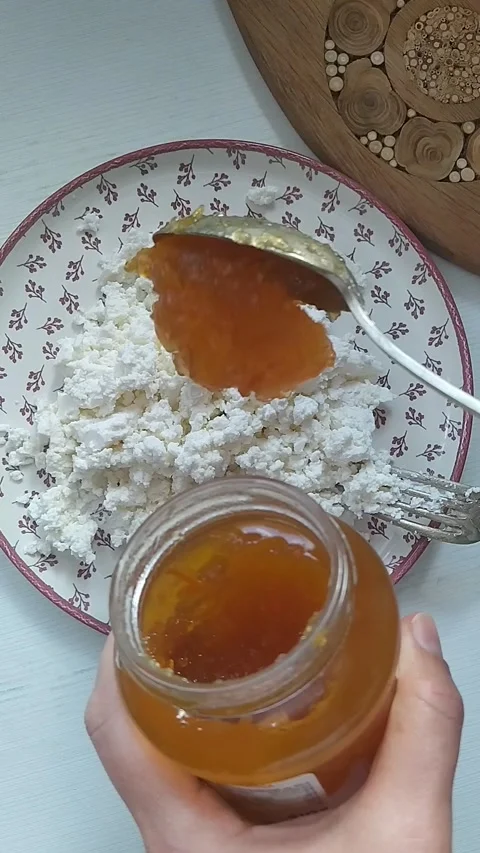 Adding Orange Jam to Cottage Cheese Stock Footage 297018363