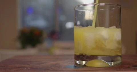 Adding Orange Juice to Cocktail in Slow Motion Видео 334021548