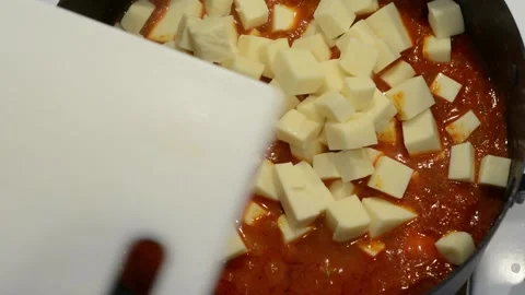 Adding Paneer to the Curry Stock Footage 136059309