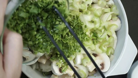 Adding parsley roots and spices overhead Stock Footage 121119787