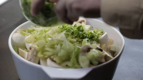 Adding parsley roots and spices Stock Footage 121120619