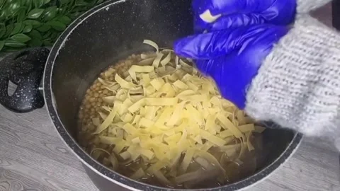 Adding Pasta to Lebanese Harra Esbao Stew with Lentils - HD Stock Footage Stock Footage 343874076