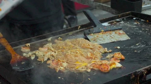 Adding Peanuts to Pad Thai Video stock 308628568